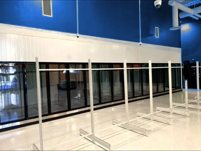 Glass walk-in cooler display doors in a grocery store