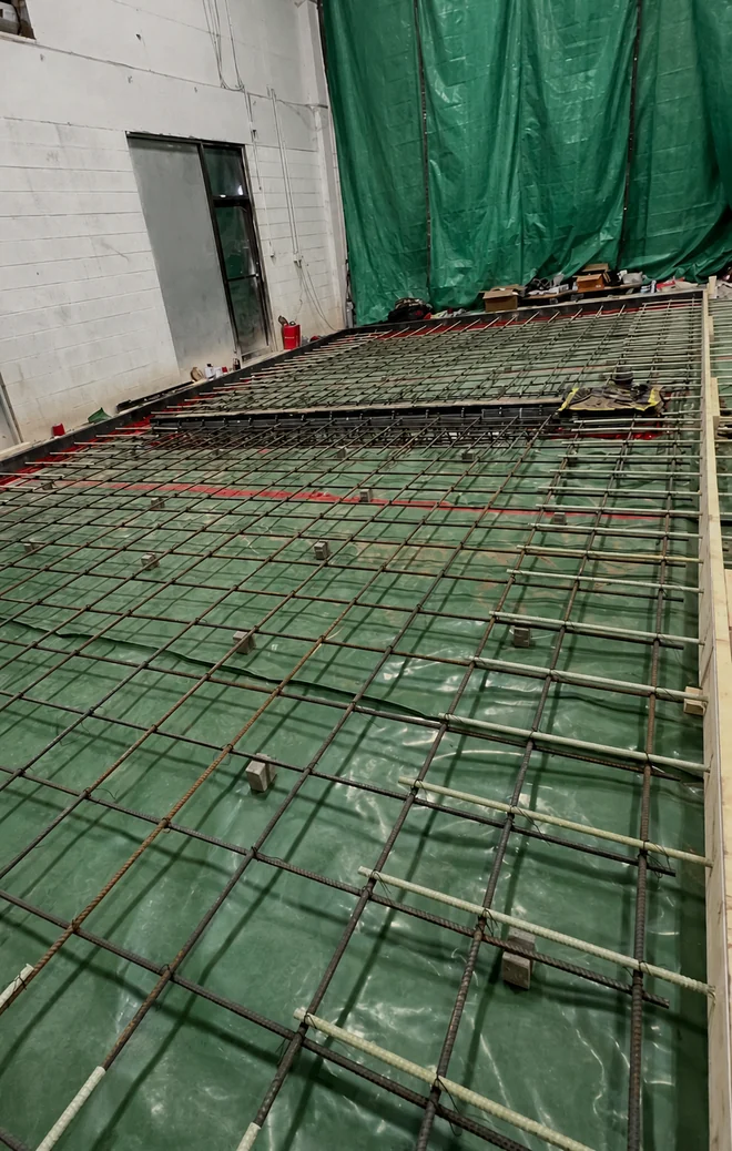 Rebar grid over insulation for a commercial freezer floor slab
